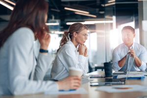 Reunión de dos mujeres y un hombre empresarios que trabajan después de realizar un máster en finanzas